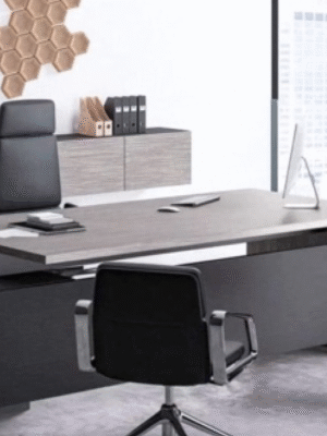 Executive desk with a distinctive design made of MDF wood and PVC veneer, supported by a side panel
