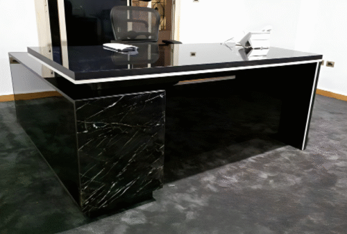Executive desk with a distinctive design made of MDF wood and PVC veneer, supported by a side panel