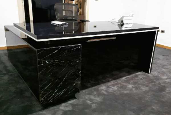 Executive desk with a distinctive design made of MDF wood and PVC veneer, supported by a side panel